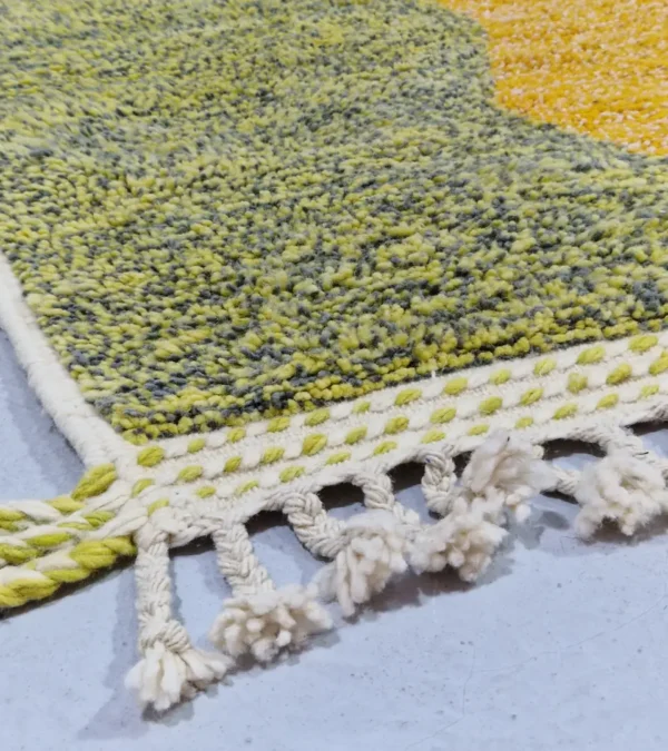 Detailed View of Naya handmade Azilal wool rug with a contemporary color blocks design in yellow, green, pink, brown, and ivory