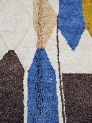 Detailed VIew of Nayla handmade Beni Ourain wool rug with a vibrant multicolor geometric design and a high/low textured pile