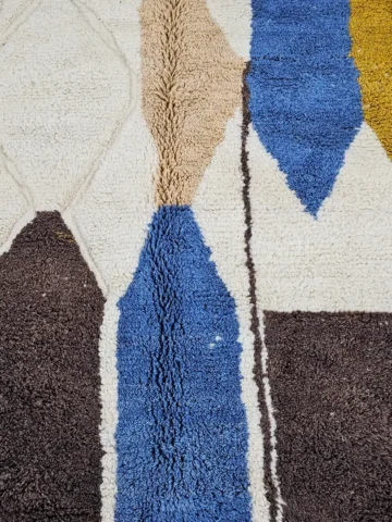 Detailed VIew of Nayla handmade Beni Ourain wool rug with a vibrant multicolor geometric design and a high/low textured pile