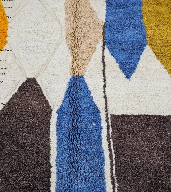Detailed VIew of Nayla handmade Beni Ourain wool rug with a vibrant multicolor geometric design and a high/low textured pile
