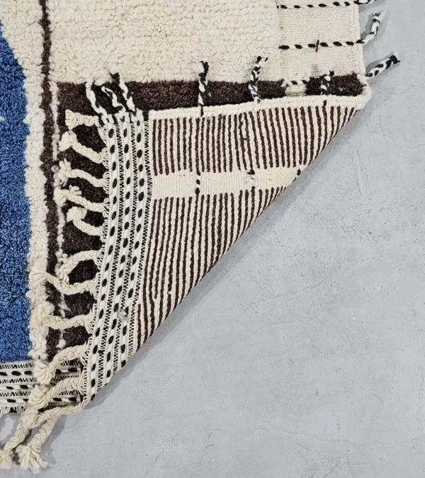 Detailed VIew of Nayla handmade Beni Ourain wool rug with a vibrant multicolor geometric design and a high/low textured pile