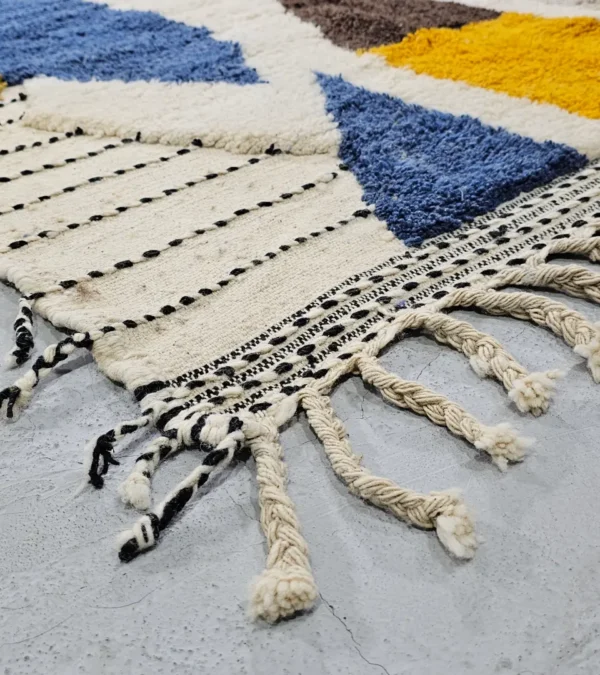 Detailed VIew of Nayla handmade Beni Ourain wool rug with a vibrant multicolor geometric design and a high/low textured pile