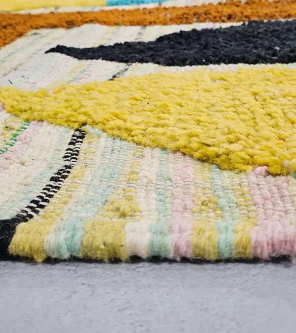 Zoomed In View Nayla handmade Azilal wool rug with a bohemian patchwork abstract design in multiple colors
