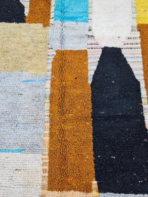 Detailed View of Nayla handmade Azilal wool rug with a bohemian patchwork abstract design in multiple colors