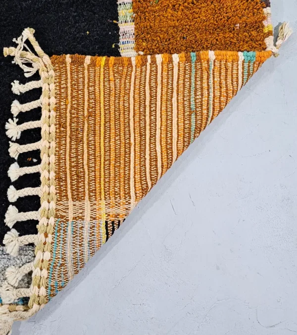 Detailed View of Nayla handmade Azilal wool rug with a bohemian patchwork abstract design in multiple colors