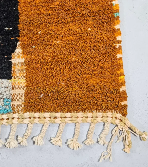 Detailed View of Nayla handmade Azilal wool rug with a bohemian patchwork abstract design in multiple colors