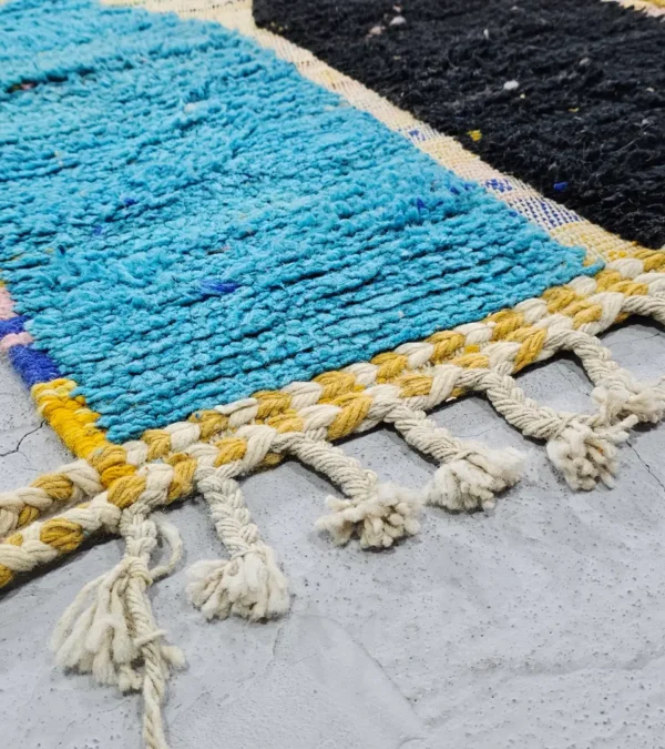 Detailed View of Nayla handmade Azilal wool rug with a bohemian patchwork abstract design in multiple colors