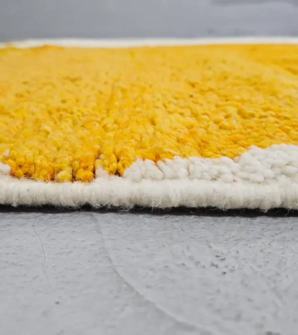 Zoomed In View of Neo handmade Beni Ourain wool rug with a bold abstract design in mustard yellow and olive green