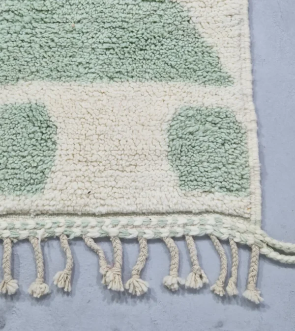 Detailed View of Handmade Moroccan rug with a modern abstract interlocking geometric design in neon green and off-white