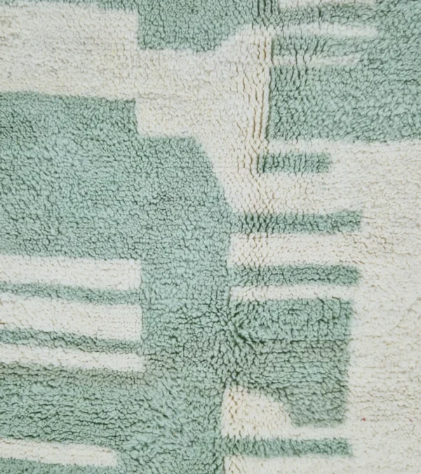 Detailed View of Handmade Moroccan rug with a modern abstract interlocking geometric design in neon green and off-white