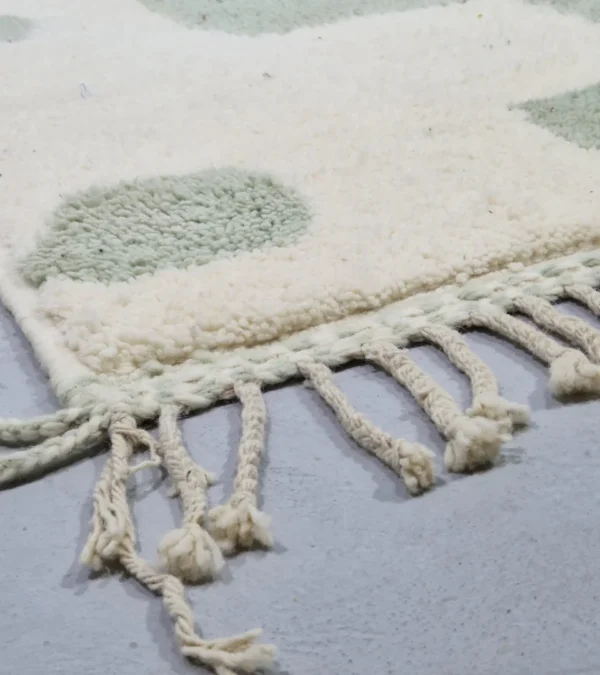 Detailed View of Handmade Moroccan rug with a modern abstract interlocking geometric design in neon green and off-white