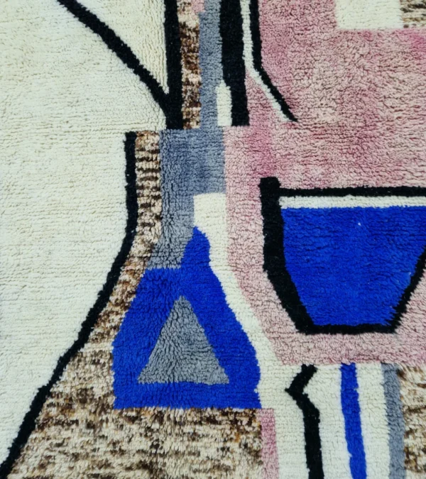 Detailed View of Handmade Moroccan wool rug with an abstract sketch design in pink, blue, brown, black, and off-white