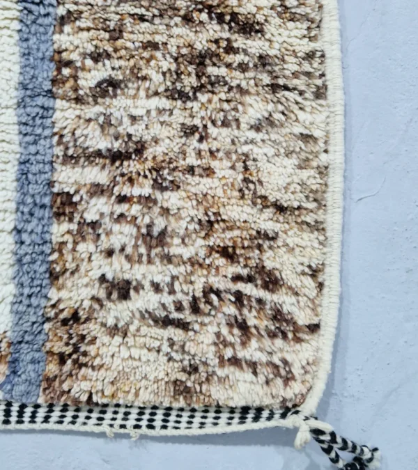 Detailed View of Handmade Moroccan wool rug with an abstract sketch design in pink, blue, brown, black, and off-white