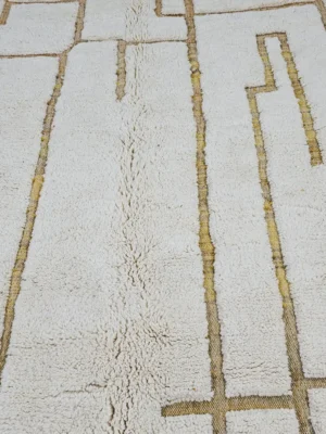 Detailed View of Noor handmade Beni Ourain wool rug with a minimalist labyrinth geometric pattern in yellow and ivory