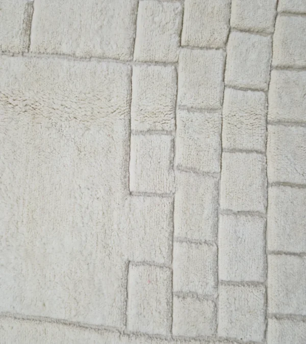 Detailed View of Handmade Moroccan wool rug in cream with raised abstract rectangles