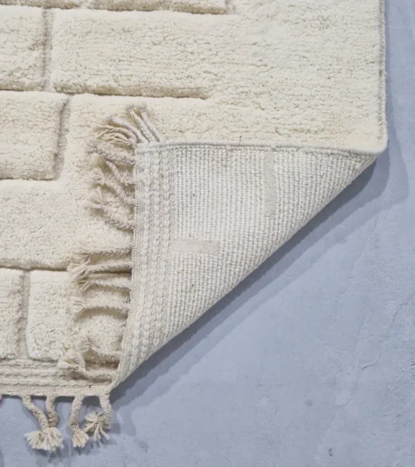 Detailed View of Handmade Moroccan wool rug in cream with raised abstract rectangles