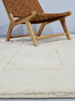 Handmade Moroccan wool rug in cream with raised abstract rectangles in room