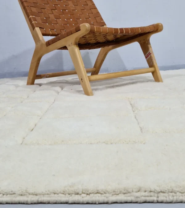 Handmade Moroccan wool rug in cream with raised abstract rectangles in room