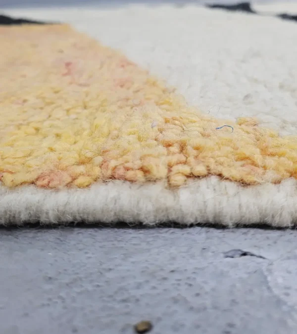 Zoomed In View of Nova handmade Beni Ourain wool rug with a contemporary curves design in navy blue, brown, mustard yellow, and ivory