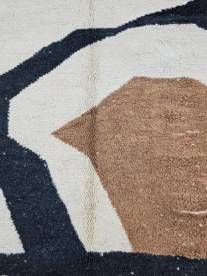 Detailed View of Nova handmade Beni Ourain wool rug with a contemporary curves design in navy blue, brown, mustard yellow, and ivory