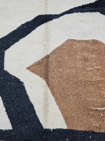 Detailed View of Nova handmade Beni Ourain wool rug with a contemporary curves design in navy blue, brown, mustard yellow, and ivory