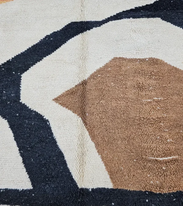 Detailed View of Nova handmade Beni Ourain wool rug with a contemporary curves design in navy blue, brown, mustard yellow, and ivory