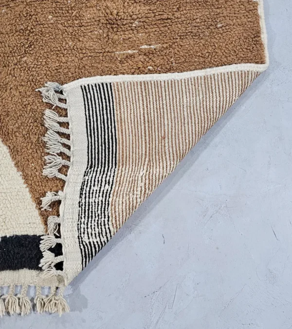 Detailed View of Nova handmade Beni Ourain wool rug with a contemporary curves design in navy blue, brown, mustard yellow, and ivory
