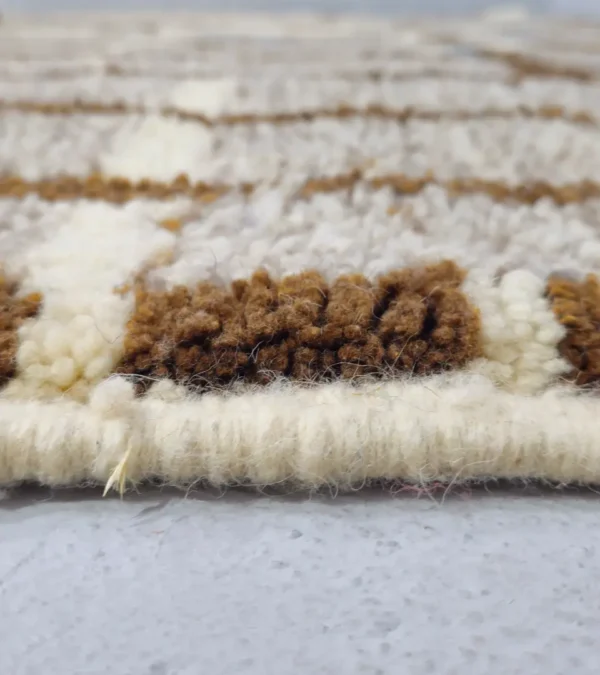 Zoomed In View of Orin handmade Azilal wool rug with an abstract linear design in gray, brown, ivory, and light blue