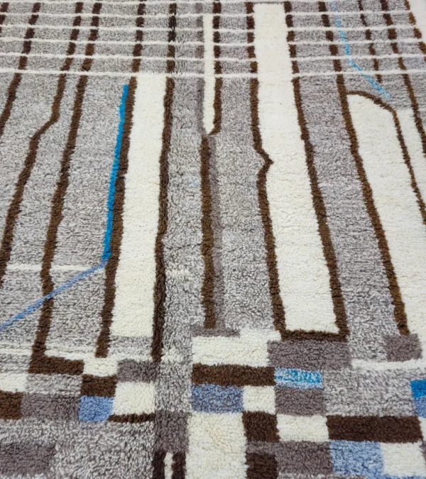 Detailed View of Orin handmade Azilal wool rug with an abstract linear design in gray, brown, ivory, and light blue