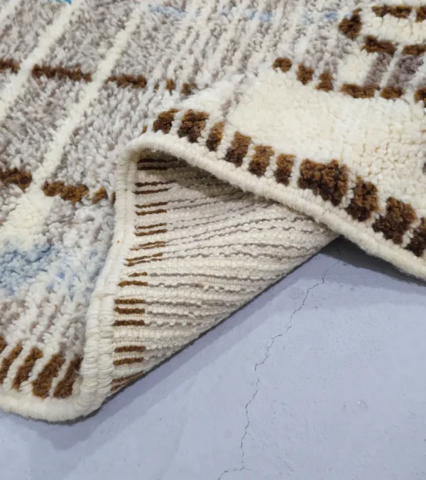 Detailed View of Orin handmade Azilal wool rug with an abstract linear design in gray, brown, ivory, and light blue