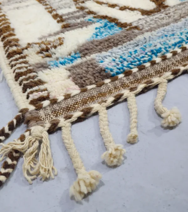 Detailed View of Orin handmade Azilal wool rug with an abstract linear design in gray, brown, ivory, and light blue