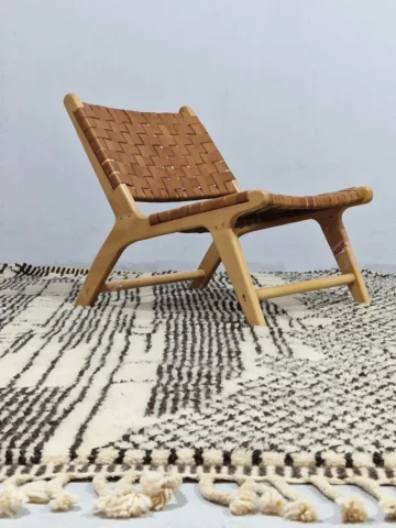 Riad handmade Moroccan wool rug with an intricate black and ivory textured design in room