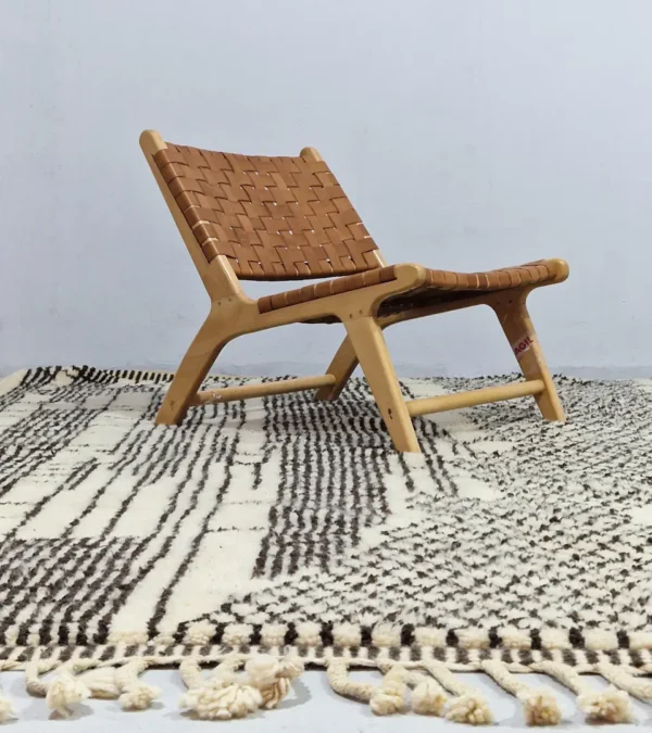 Riad handmade Moroccan wool rug with an intricate black and ivory textured design in room