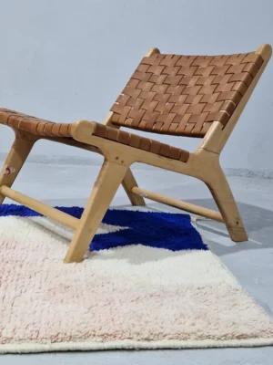 Rima handmade Beni Ourain wool rug with a contemporary abstract design in multicolor hues including blush pink, off-white, and royal blue to indigo in room