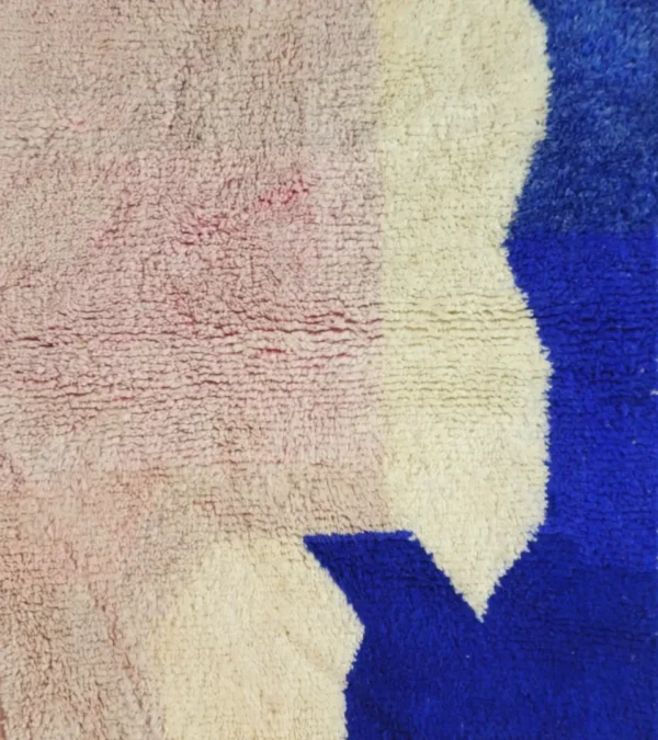 Detailed View of Rima handmade Beni Ourain wool rug with a contemporary abstract design in multicolor hues including blush pink, off-white, and royal blue to indigo