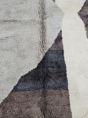 Detailed View of Rita handmade Beni Mrirt wool rug with a modern abstract design in shades of charcoal gray, light gray, and ivory