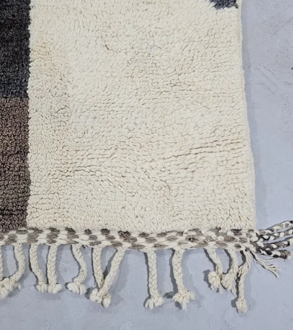 Detailed View of Rita handmade Beni Mrirt wool rug with a modern abstract design in shades of charcoal gray, light gray, and ivory