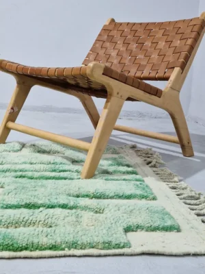 Ruby handmade Moroccan wool rug with a textured, raised abstract design in green and ivory in room