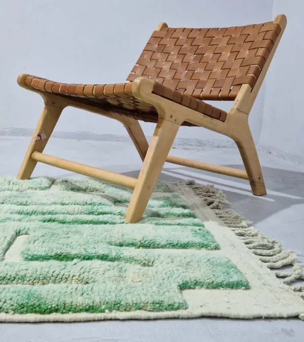 Ruby handmade Moroccan wool rug with a textured, raised abstract design in green and ivory in room