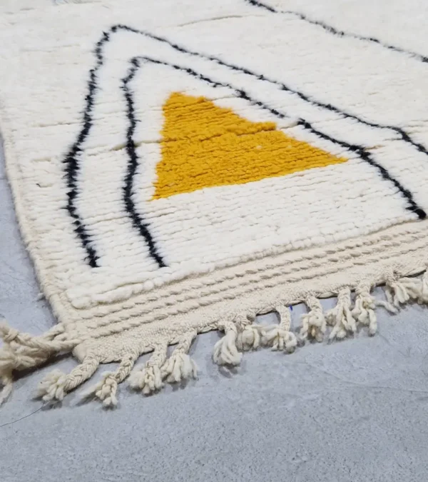 Detailed View of Salma handmade Azilal wool rug with a minimalist geometric design featuring a yellow triangle, teal rectangle, and burgundy rectangle on an ivory background