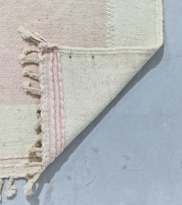 Detailed View of Sana handmade Kilim flatweave wool rug with color blocks in off-white, teal, and beige, with yellow trapezoids