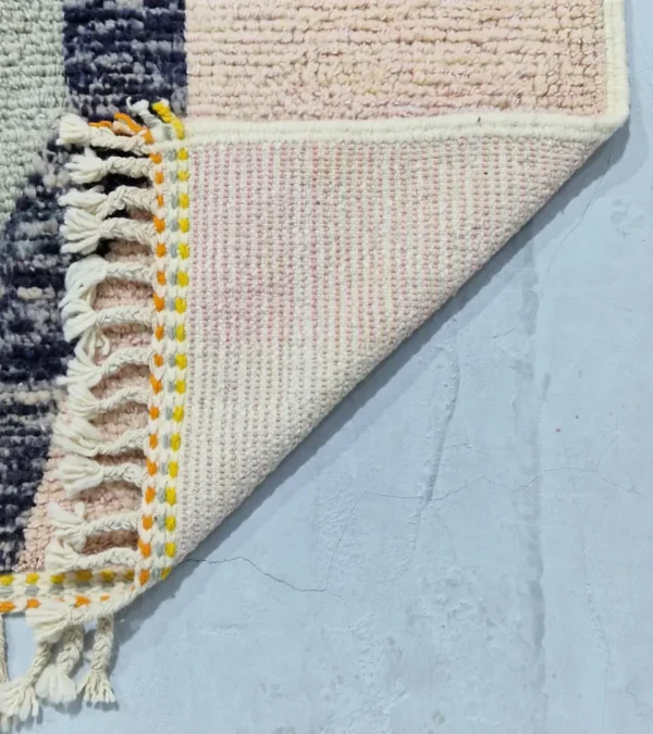 Detailed View of Sanaa handmade Beni Ourain wool rug with a contemporary abstract design in multicolor hues including lavender, grayish-green, mustard yellow, dark teal, and golden brown