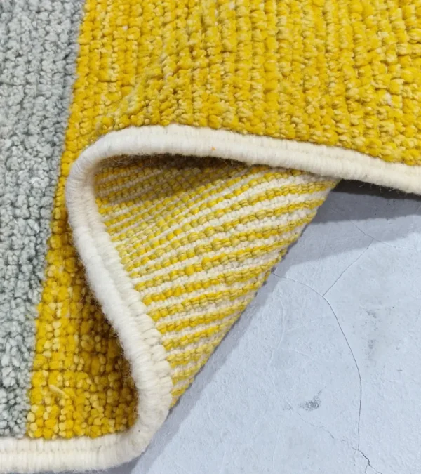 Detailed View of Sanaa handmade Beni Ourain wool rug with a contemporary abstract design in multicolor hues including lavender, grayish-green, mustard yellow, dark teal, and golden brown