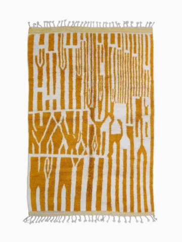 Top View of Sara handmade Beni Ourain wool rug with a modern striped and abstract design in yellow and ivory