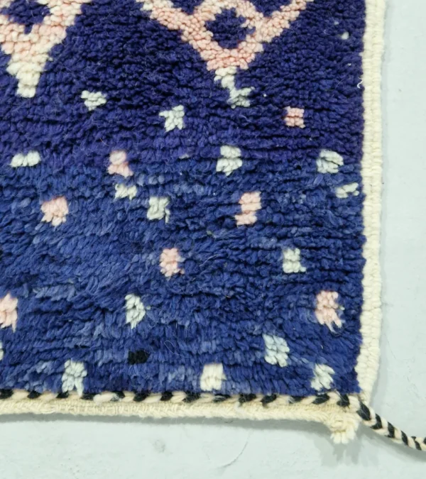 Detailed View of Handmade Moroccan wool rug with an abstract geometric design in pink, blue, and black