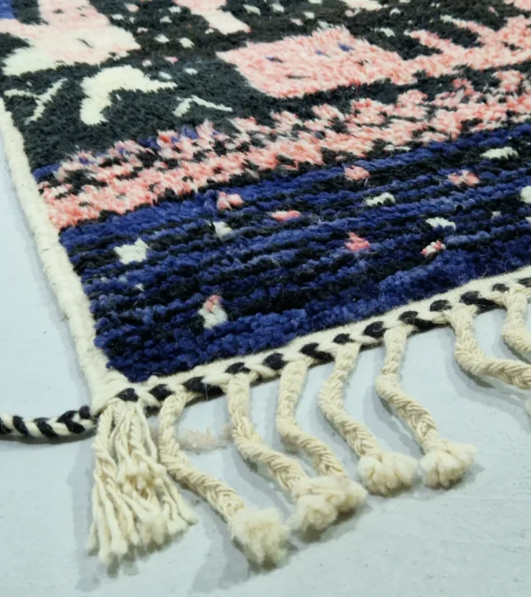 Detailed View of Handmade Moroccan wool rug with an abstract geometric design in pink, blue, and black