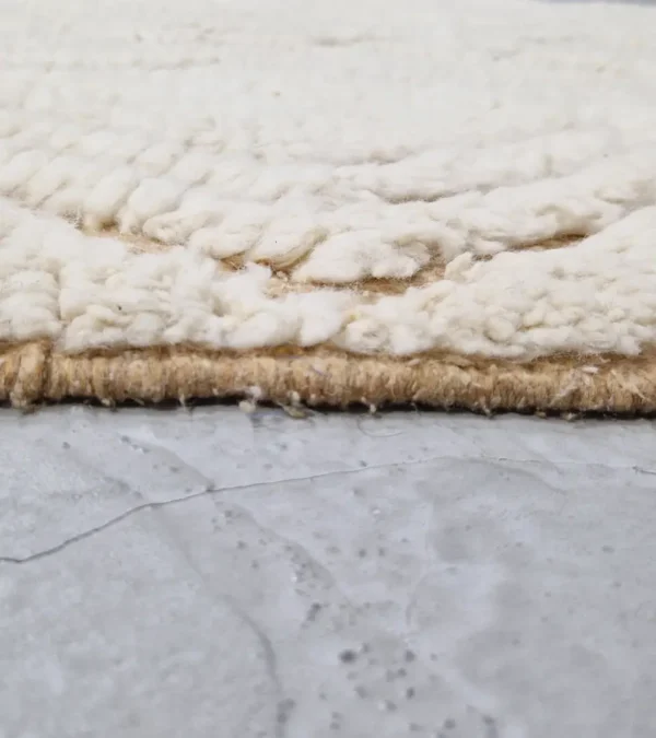 Zoomed In View of Sirine handmade Beni Ourain wool rug with a classic trellis pattern and a raised, textured pile