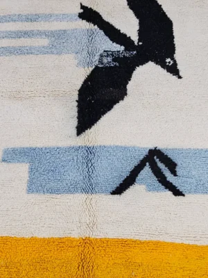 detailed view of Sofia handmade Moroccan wool rug with a minimalist design of abstract birds in flight