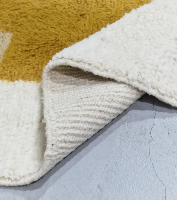 Detailed View of Soma handmade Beni Ourain wool rug with a modern abstract design featuring blocks of yellow, beige, and maroon