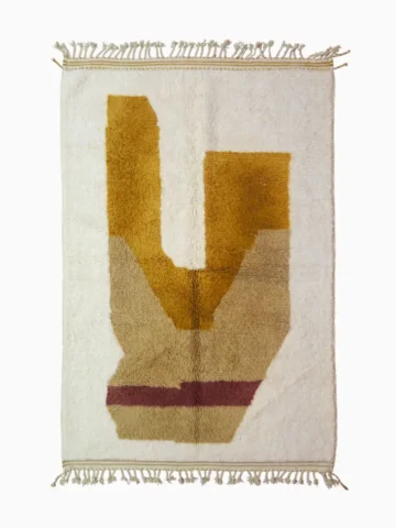Top View of Soma handmade Beni Ourain wool rug with a modern abstract design featuring blocks of yellow, beige, and maroon